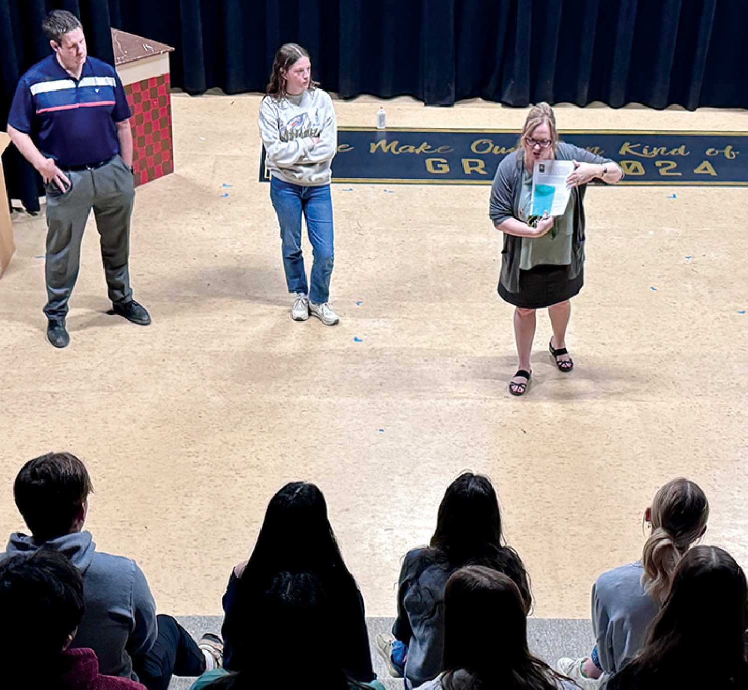 Town Councillor Murray Gray, Molly Martens, and Principal Sherrie Meredith speak to McNaughton grade 10 students about the youth councillor position.